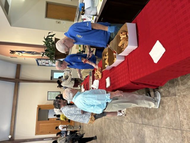 Knights providing donuts, pastries and coffee after mass to the Immaculate Conception community.
